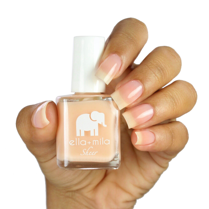 Bare sheer nude nail polish on a medium skin tone, hand holding the bottle