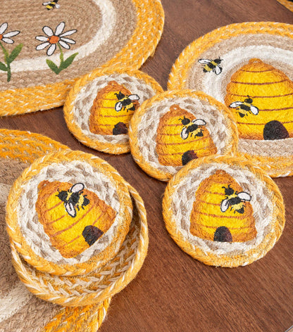 Set of braided jute coasters with bee and beehive designs. Yellow, tan and white jute for a summer vibe.