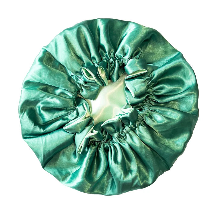 green satin hair bonnet on a white background