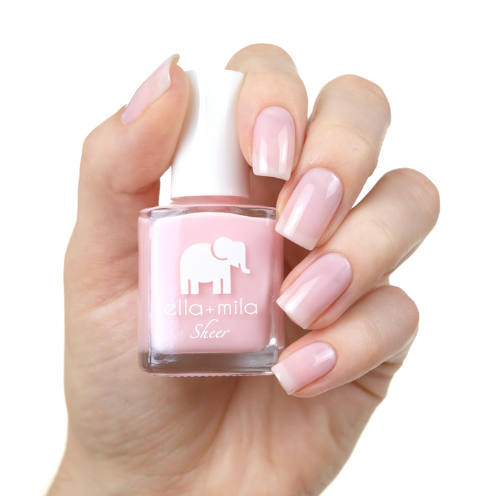 Dream sheer baby pink nail polish manicure on a light skin tone with the bottle
