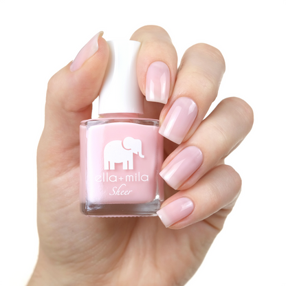 Dream sheer baby pink nail polish manicure on a light skin tone with the bottle