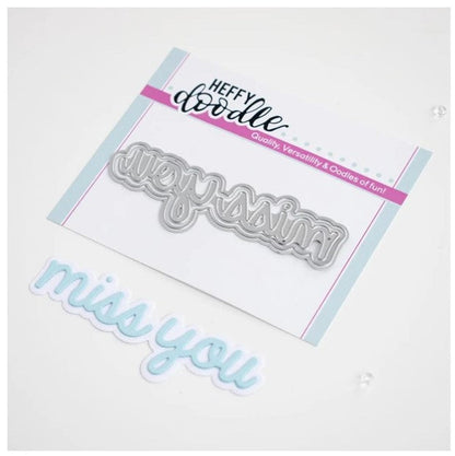 Heffy Doodle - Heffy Cuts Die - Miss You. A metal cutting die of the words 'Miss You’ in a script font style, in addition to a matching outline die to create a shadow matt layer. Use together or separately to create different looks for your projects. Measuring approximately 3.5"x1.25". Available at Embellish Away located in Bowmanville Ontario Canada.