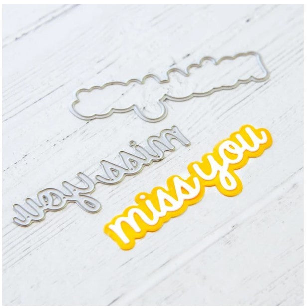 Heffy Doodle - Heffy Cuts Die - Miss You. A metal cutting die of the words 'Miss You’ in a script font style, in addition to a matching outline die to create a shadow matt layer. Use together or separately to create different looks for your projects. Measuring approximately 3.5"x1.25". Available at Embellish Away located in Bowmanville Ontario Canada. Die cut example