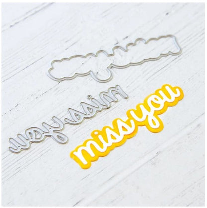 Heffy Doodle - Heffy Cuts Die - Miss You. A metal cutting die of the words 'Miss You’ in a script font style, in addition to a matching outline die to create a shadow matt layer. Use together or separately to create different looks for your projects. Measuring approximately 3.5"x1.25". Available at Embellish Away located in Bowmanville Ontario Canada. Die cut example