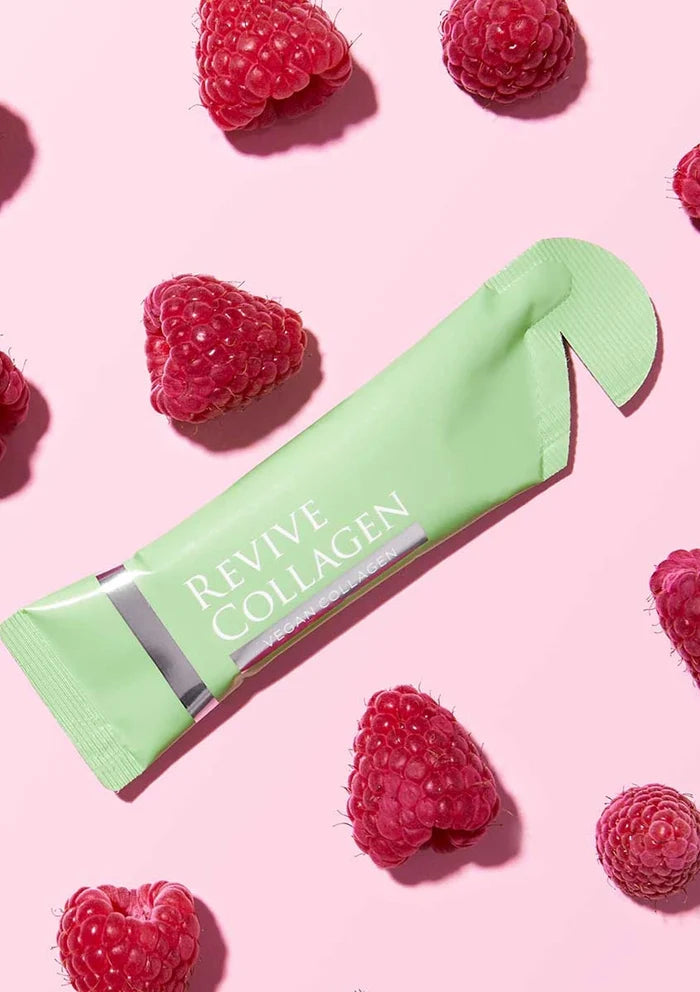 Revive Collagen package with raspberries on a pink background