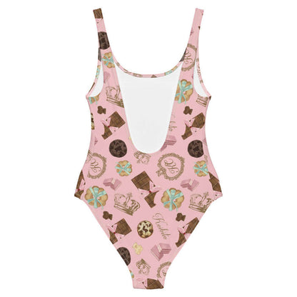Royal Cookie kawaii one-piece swimsuit in strawberry pink with gold crowns and milk-chocolate bars