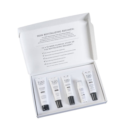 Opened TiZO Photoceutical Skincare Skin Revitalizing Regimen box with TiZO Mini Gentle Amino Gel Cleanser, TiZO Mini Complexion Brightener, TiZO Mini Daily Moisture, TiZO Mini Eye Renewal Non-Tinted, and TiZO Mini AM Replenish Lightly Tinted.