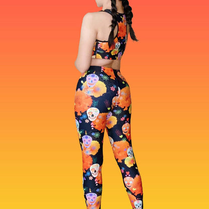 Sugar Skull kawaii leggings, back view, with painted calaveras and cempasúchil blooms on black